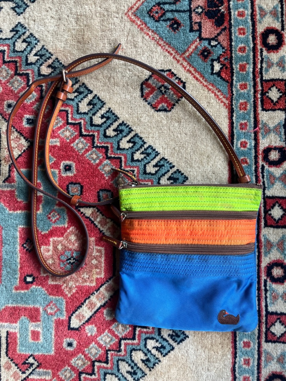 Dooney & Bourke blue canvas, small multicolored Crossbody zipper bag.